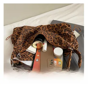 Spacious interior of leopard print tote bag showing storage for tablet and cosmetics