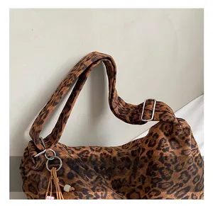 Detail of adjustable wide shoulder strap with silver buckle on leopard print tote bag