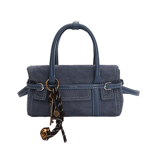 Minimalist navy blue frosted handbag with top handles and decorative charm detail