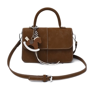 Brown frosted leather tote bag with horse charm and adjustable strap on white background