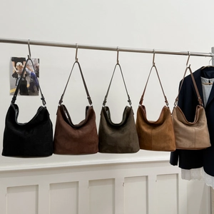 Five colors of soft suede hobo bags hanging on display, showing large capacity and texture