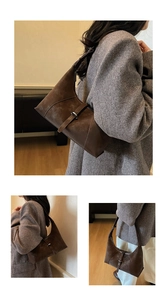 Detailed close-up of brown suede crescent bag with vintage buckle and retro texture