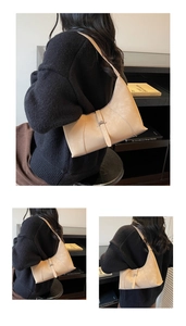 Three-way view of a cream hobo shoulder bag styled with a minimalist black outfit