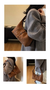 Detail view of a vintage brown asymmetrical shoulder bag with decorative buckle accent
