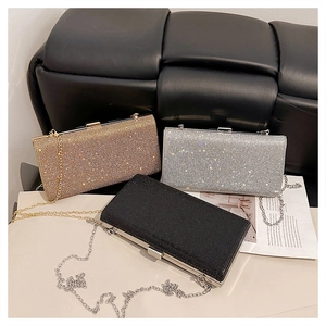 Three elegant evening clutch bags in gold, silver, and black with shiny rhinestones