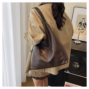 Detailed view of the large chocolate brown leather hobo bag showing its slouchy design