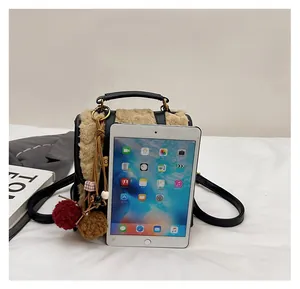 Mini faux fur backpack size comparison with a tablet showing compact proportions