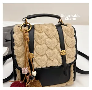 Detail of faux fur heart texture and detachable charm on vintage backpack