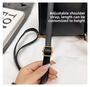 Detail of adjustable black leather strap with vintage bronze buckle on retro backpack