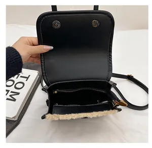 Detail view of the black faux leather backpack interior with zipper pocket and plush trim