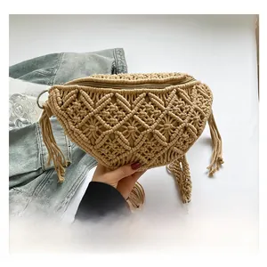 Detail of beige woven cotton shoulder bag with hollow diamond pattern and side tassels