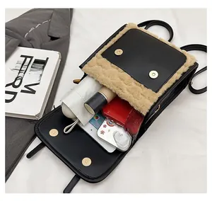 Internal capacity of the retro backpack showing phone, cosmetics and umbrella storage