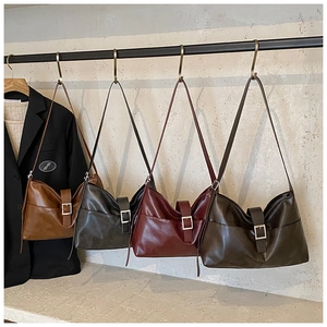 Detail view of four minimalist leather hobo bags in brown, grey, wine and coffee colors