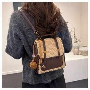 Detail of vintage patchwork backpack with fur trim and heart quilting on a model