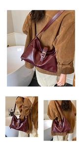 Detail of burgundy tote bag showing silver buckle closure and textured faux leather finish