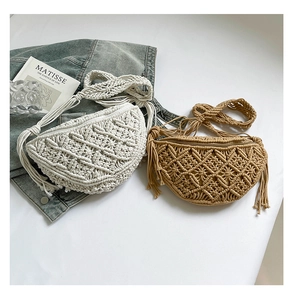 Macro view of handmade macramé straw shoulder bags with fringe detail and woven patterns