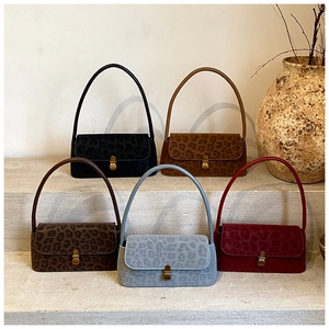 Close-up of leopard print underarm bags in five colors with vintage gold buckles