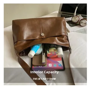 Detail view of large brown vintage leather tote bag showing internal storage capacity