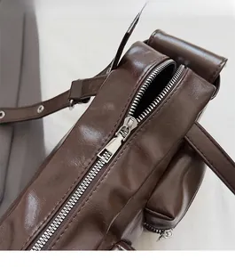 Detailed macro view of smooth silver metal zipper on a dark brown leather handbag