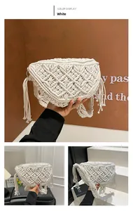Detailed macro view of white bohemian hand-woven straw shoulder bag with stylish tassels