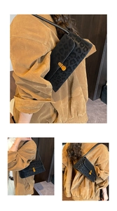 Detail of leopard print shoulder bag with gold clasp and black leather strap