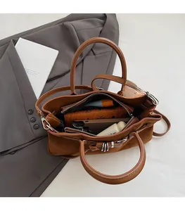 Spacious interior of brown suede tote bag showing capacity for wallet and smartphone