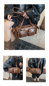 Detail view of brown vintage leather shoulder bag with functional zipper pockets