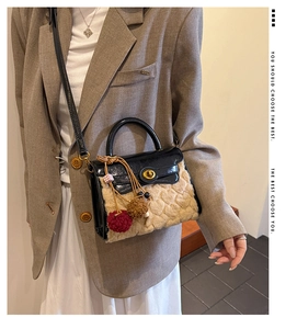 Detail of lamb wool handbag with patent leather flap and golden rotary lock clasp