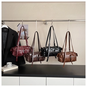 Detailed row of vintage multi-pocket shoulder bags in four colors with silver hardware