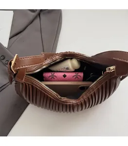Macro view of the brown crescent bag interior showing large capacity for daily items