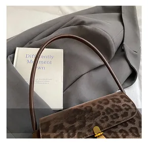 Detail of leopard print handbag with soft texture and vintage gold metal lock buckle
