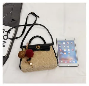 Detailed size comparison of beige faux fur Kelly bag with iPad mini and gold lock