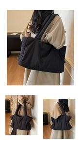 Detail of black quilted puffer tote bag with side drawstrings shown on shoulder
