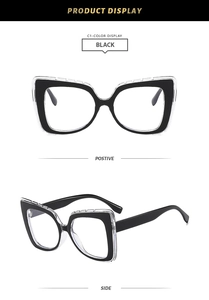 Detail of black double-layered cat-eye frames with clear outer overlay and square shape