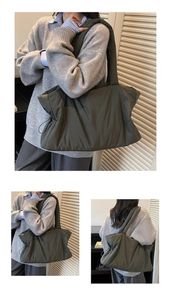 Detail of dark green quilted tote bag with side drawstring and padded shoulder strap