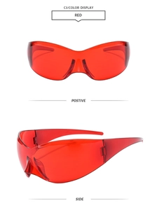 Macro view of red oversized butterfly frame sunglasses with futuristic wrap-around design