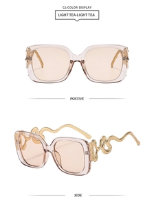 Detail view of square brown sunglasses featuring golden snake-shaped metal temples and frame