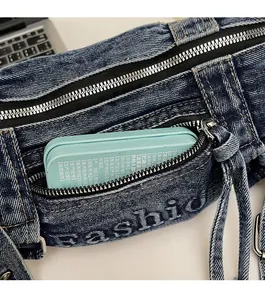 Close-up of vintage washed denim crossbody bag featuring zipper pocket and fashion logo