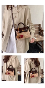 Detail of khaki plush handbag featuring heart embossed texture and brown leather strap