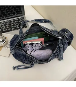 Spacious interior of washed denim hobo bag showing capacity for phone and wallet