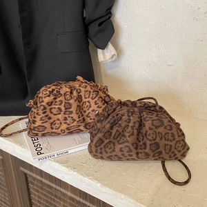 Detailed view of leopard print ruched cloud bags with slender leather shoulder straps
