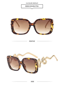 Detail of snake-shaped golden metal temples on dark tortoiseshell oversized sunglasses