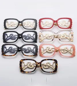 Macro shot of stylish gold snake-shaped metal temples on square oversized glasses