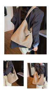 Detail view of khaki hobo shoulder bag with soft leather texture and wide strap