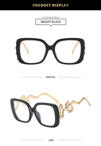 Detail of square black frame glasses featuring gold snake-shaped temples and brand logo