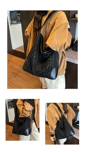Close-up of leopard print tote bag featuring black suede fabric and leather corners