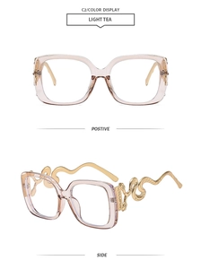 Detail of light tea square frame glasses with golden snake-shaped metal temples