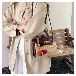 Detail of a vintage contrast patchwork crossbody bag in plush beige and dark brown leather