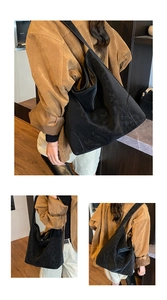 Black large capacity tote bag with matte suede texture and wide strap for daily commute