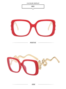 Detail of red square frames with golden snake-shaped metal temples and embossed design